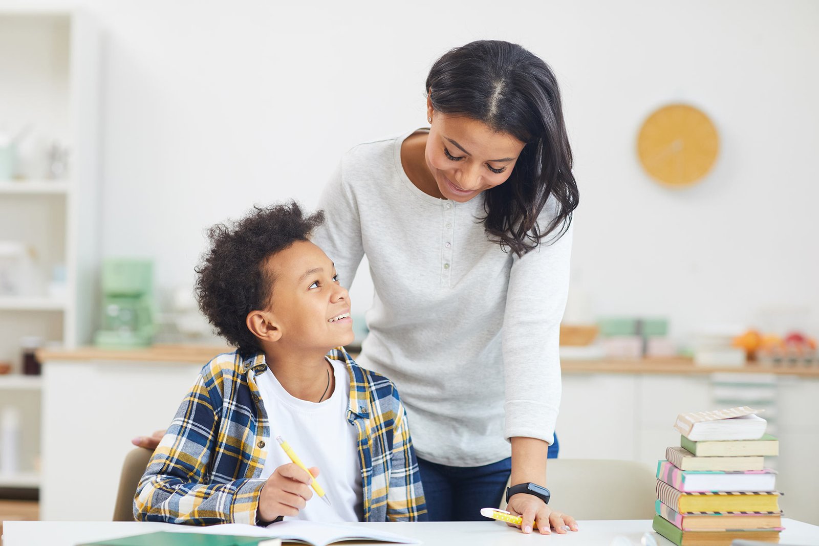 smiling-african-boy-doing-homework-with-mom-2022-02-01-22-37-03-utc.jpg